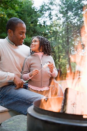 Father and daughter by fire Stock Photo - Premium Royalty-Free, Code: 6116-08945518