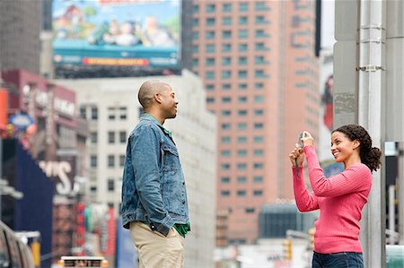 person standing back building street - Woman photographing man Stock Photo - Premium Royalty-Free, Code: 6116-08945689