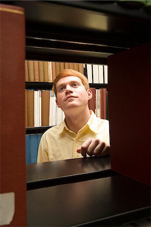 simsearch:649-06812246,k - Male student studying in the library Stock Photo - Premium Royalty-Free, Code: 6116-08945813
