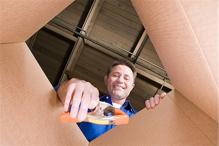 Man and cardboard box Stock Photo - Premium Royalty-Free, Code: 6116-08915223