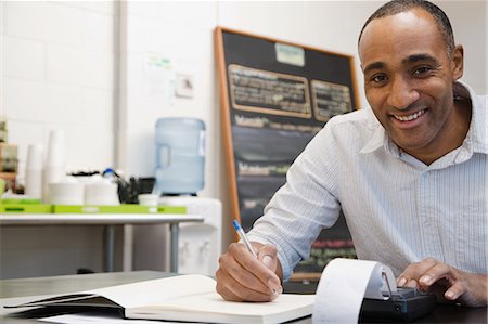 startup writing - Man doing accounts in cafe Stock Photo - Premium Royalty-Free, Code: 6116-08915330