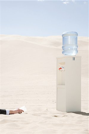 dead people in deserts - Person reaching for water cooler in desert Stock Photo - Premium Royalty-Free, Code: 6116-08915492