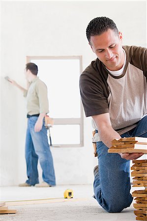 simsearch:6116-08915377,k - A man holding planks of wood Stock Photo - Premium Royalty-Free, Code: 6116-08915410