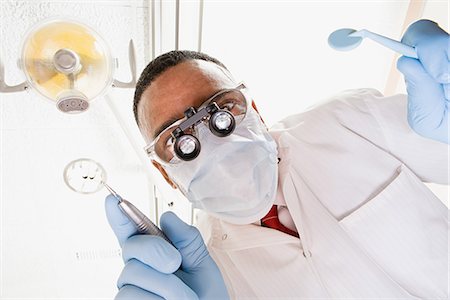 Low angle view of dentist and dental nurse Stock Photo - Premium Royalty-Free, Code: 6116-08915589