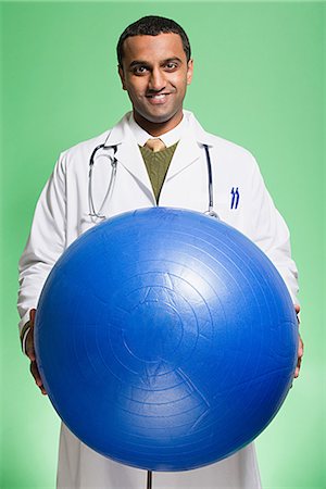 Doctor holding an exercise ball Stock Photo - Premium Royalty-Free, Code: 6116-08915604