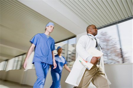 Doctor and surgeons walking Stock Photo - Premium Royalty-Free, Code: 6116-08915712