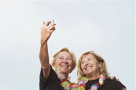 senior sisters happy two people - Women taking a picture of themselves Stock Photo - Premium Royalty-Free, Code: 6116-08915854