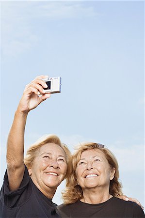 senior sisters happy two people - Women taking a picture of themselves Stock Photo - Premium Royalty-Free, Code: 6116-08915902