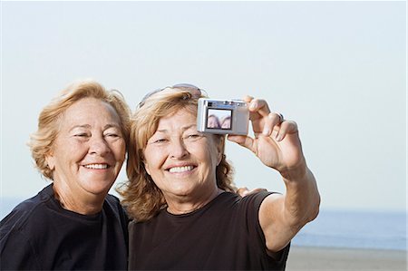 senior sisters happy two people - Women taking a picture of themselves Stock Photo - Premium Royalty-Free, Code: 6116-08915910