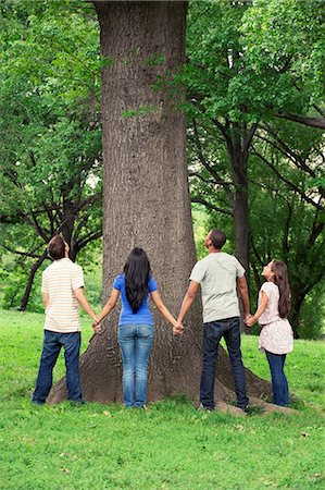 Teenage friends spending time together at tree Stock Photo - Premium Royalty-Free, Code: 6116-08916096