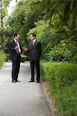 Chinese businessmen in a park Stock Photo - Premium Royalty-Free, Code: 6116-09013547