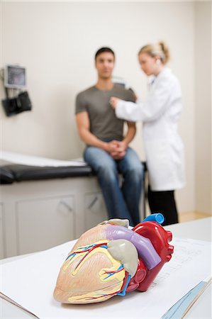 doctor checkup models pictures - Model heart and patient being examined Stock Photo - Premium Royalty-Free, Code: 6116-09013566