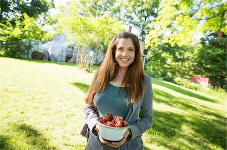 farmhouse - On The Farm. A Woman Carrying A Bowl Of Organic Fresh Picked Strawberries. Stock Photo - Premium Royalty-Free, Code: 6118-07121818