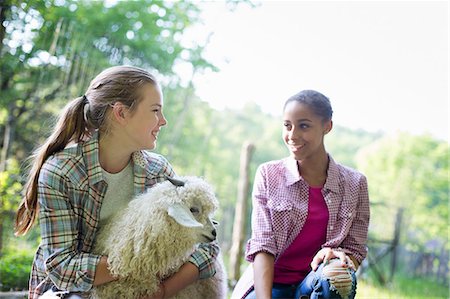 Two Young Girls On The Farm, Outdoors. One With Her Arms Around A Very Fluffy Haired Angora Goat. Photographie de stock - Premium Libres de Droits, Code: 6118-07122250