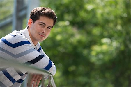 Summer. Business People. A Man Leaning On A Railing Relaxing. Off Grid. Stock Photo - Premium Royalty-Free, Code: 6118-07122272