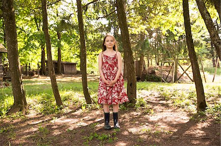 simsearch:6118-07122250,k - A Girl In A Summer Dress Standing In A Grove Of Trees. Photographie de stock - Premium Libres de Droits, Code: 6118-07122210