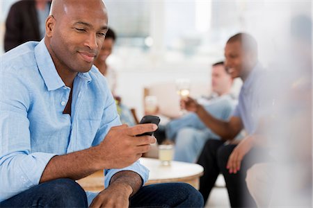 Office Event. A Man Using His Smart Phone. Stock Photo - Premium Royalty-Free, Code: 6118-07122343