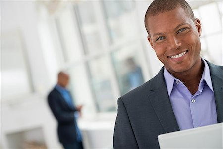 Business People. A Young Man In A Suit Using A Digital Tablet. Photographie de stock - Premium Libres de Droits, Code: 6118-07122358