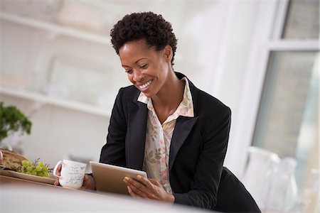 simsearch:6118-07122319,k - Business People. A Woman In A Black Jacket Using A Digital Tablet. Stock Photo - Premium Royalty-Free, Code: 6118-07122383