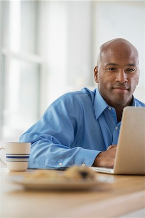 Office. A Man Sitting Using A Laptop. Stock Photo - Premium Royalty-Free, Code: 6118-07122395