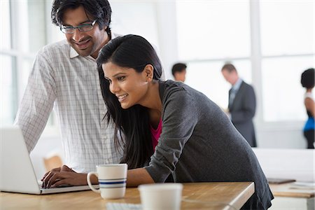 Office. A Man And A Woman Using A Laptop Computer. Stock Photo - Premium Royalty-Free, Code: 6118-07122406