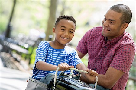 family photo usa - A Boy Riding An Old Fashioned Toy Peddle Car. Stock Photo - Premium Royalty-Free, Code: 6118-07122505