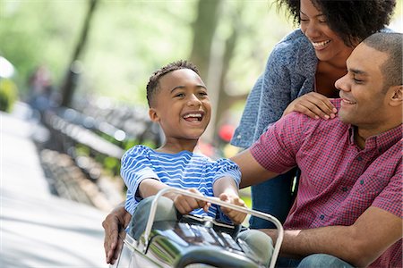 family group outdoors - A Boy Riding An Old Fashioned Toy Peddle Car. Stock Photo - Premium Royalty-Free, Code: 6118-07122506