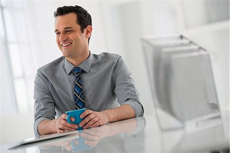 people hairstyle - Office Interior. A Man Seated At A Table. A Digital Tablet. Stock Photo - Premium Royalty-Free, Code: 6118-07122670