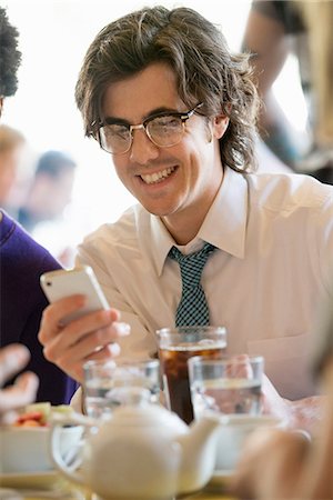 simsearch:6118-07351491,k - City Life. A Group Of People In A Café, Checking Their Smart Phones. Stock Photo - Premium Royalty-Free, Code: 6118-07122816