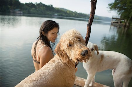 simsearch:6118-07731934,k - A woman swimming with her two dogs in a lake. Foto de stock - Sin royalties Premium, Código: 6118-07203144