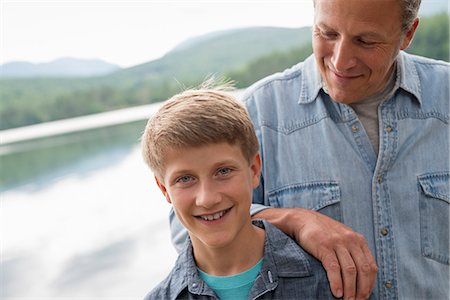 simsearch:6118-07440266,k - A family outdoors under the trees on a lake shore. Father and son. Stock Photo - Premium Royalty-Free, Code: 6118-07203117