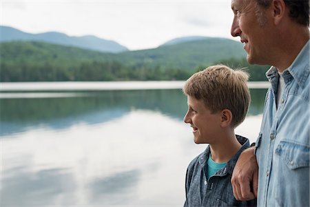 simsearch:6118-07440277,k - A family outdoors under the trees on a lake shore. Father and son. Stock Photo - Premium Royalty-Free, Code: 6118-07203116