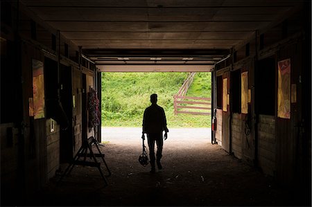 silo - An organic farm in the Catskills. A man walking through a stable. Stock Photo - Premium Royalty-Free, Code: 6118-07203338