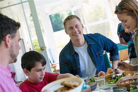 A family party around a table in a cafe. Adults and children. Stock Photo - Premium Royalty-Free, Code: 6118-07203590