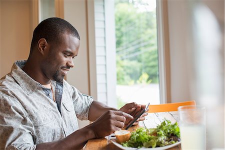 snack dish - A man sitting in a cafe with a cup of coffee, using a smart phone. Stock Photo - Premium Royalty-Free, Code: 6118-07203666