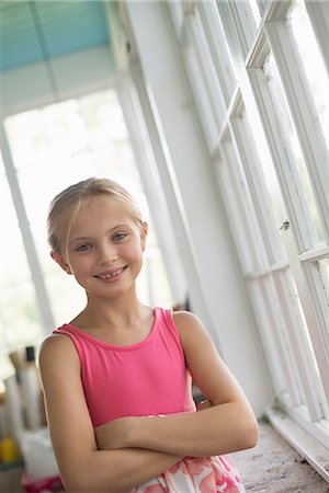 simsearch:6118-07203741,k - A young girl in a kitchen wearing a pink dress. Stock Photo - Premium Royalty-Free, Code: 6118-07203740