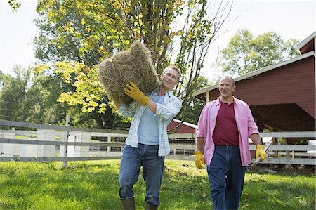 photo father and son on farm - A family summer gathering at a farm. A shared meal, a homecoming. Stock Photo - Premium Royalty-Free, Code: 6118-07235045