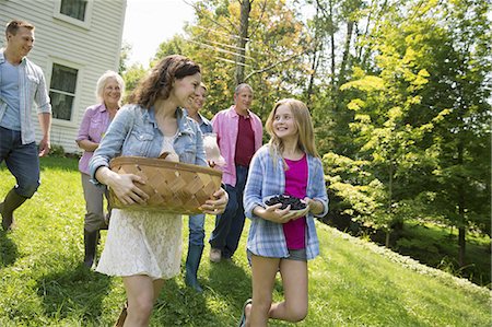 family outside picnic - A family summer gathering at a farm. A shared meal, a homecoming. Stock Photo - Premium Royalty-Free, Code: 6118-07235031