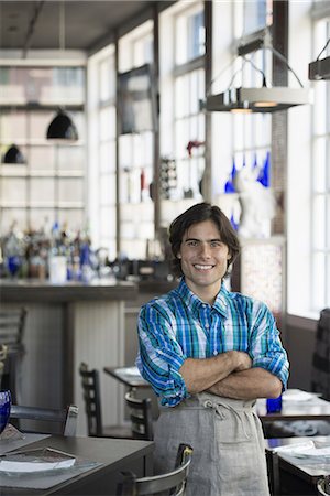 restaurant in us - A cafe interior. A waiter in a checked shirt. Stock Photo - Premium Royalty-Free, Code: 6118-07235101