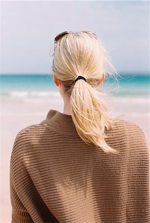 simsearch:6118-09144911,k - A blonde haired woman looking out to sea from the shore. Stock Photo - Premium Royalty-Free, Code: 6118-07351096