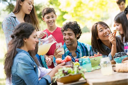 Adults and children around a table in a garden. Stock Photo - Premium Royalty-Free, Code: 6118-07351198