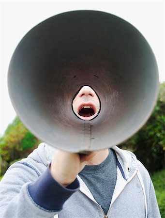 pov - A man using a megaphone in the open air. Stock Photo - Premium Royalty-Free, Code: 6118-07351279