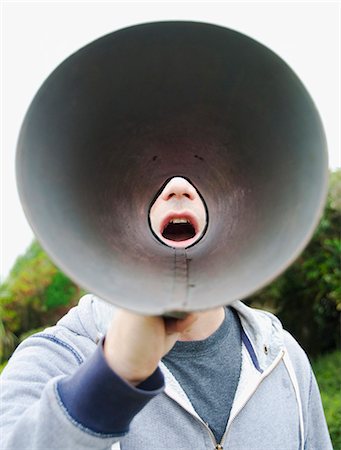 point of view person - A man using a megaphone in the open air. Stock Photo - Premium Royalty-Free, Code: 6118-07351279