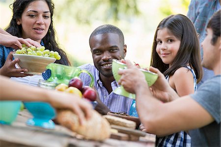 simsearch:6118-07769547,k - Adults and children around a table at a party in a garden. Stock Photo - Premium Royalty-Free, Code: 6118-07351204