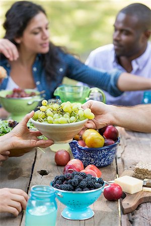 Adults and children around a table at a party in a garden. Stock Photo - Premium Royalty-Free, Code: 6118-07351205