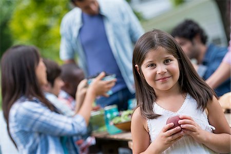 A summer party outdoors. Adults and children around a table. Stock Photo - Premium Royalty-Free, Code: 6118-07351216