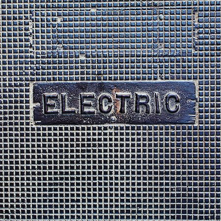 simsearch:6118-07352659,k - A utility cover made of metal, with the word Electric. Stock Photo - Premium Royalty-Free, Code: 6118-07351306