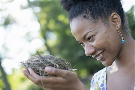 summer hairstyle - A woman holding a bird nest in her hands. Stock Photo - Premium Royalty-Free, Code: 6118-07351591