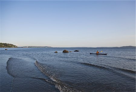 simsearch:6118-07352544,k - A sea kayaker in the water at sunset off the coast of Seattle in Puget Sound, Washington, USA. Stock Photo - Premium Royalty-Free, Code: 6118-07351709