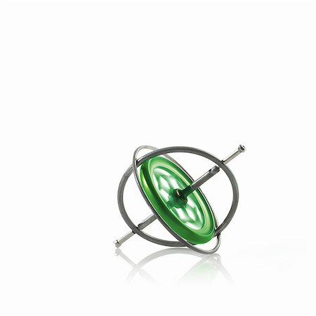 simsearch:6118-07440380,k - Small metallic object, a gyroscope or spinning wheel with a green patterned centre. Stock Photo - Premium Royalty-Free, Code: 6118-07351717